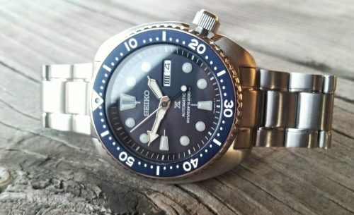 Seiko SRP773 laying on wooden table